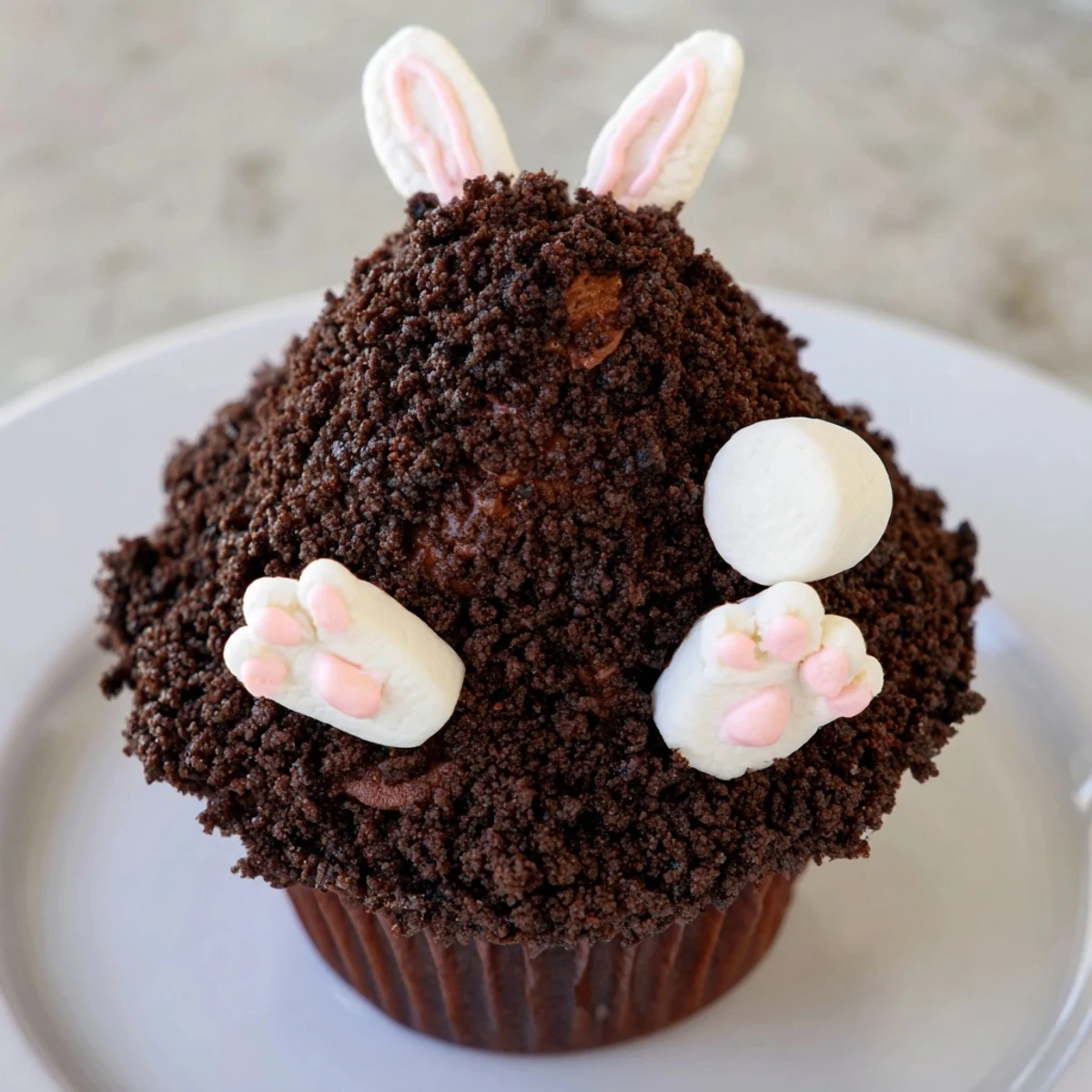 Easter-themed Bunny Burrow Cupcake Tray: chocolate cupcakes are decorated like bunny burrows with fondant feet.