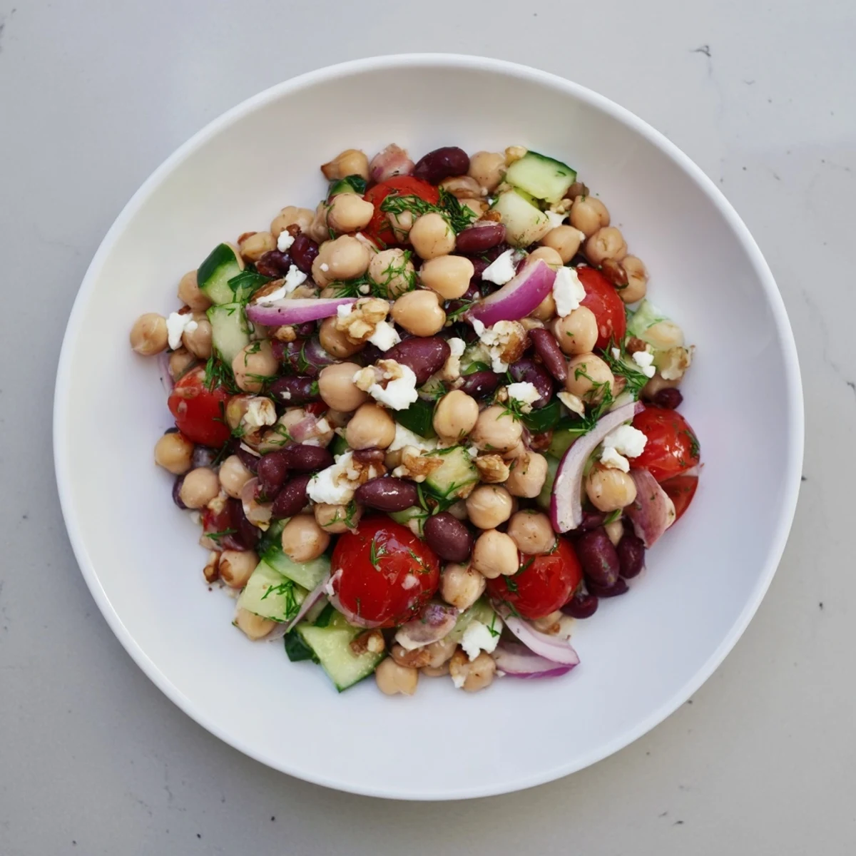Close-up of a refreshing Dense Bean Salad, featuring hearty beans and the tart cherry vinaigrette.