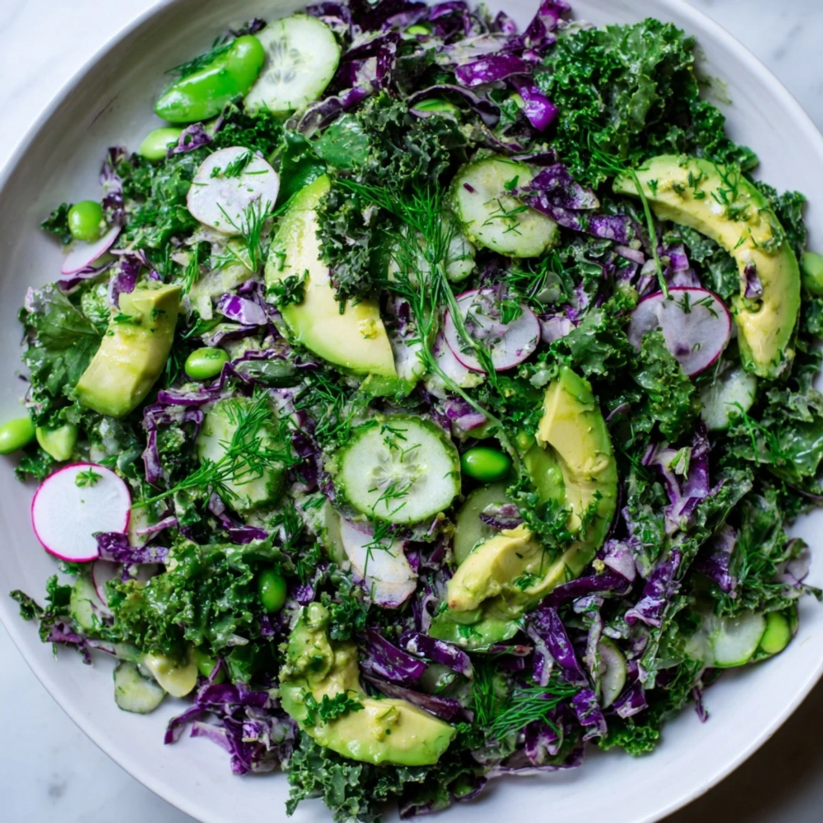 A bowl of Green Goddess Detox Cabbage Salad, tossed with a tangy dressing for a healthy, light meal.