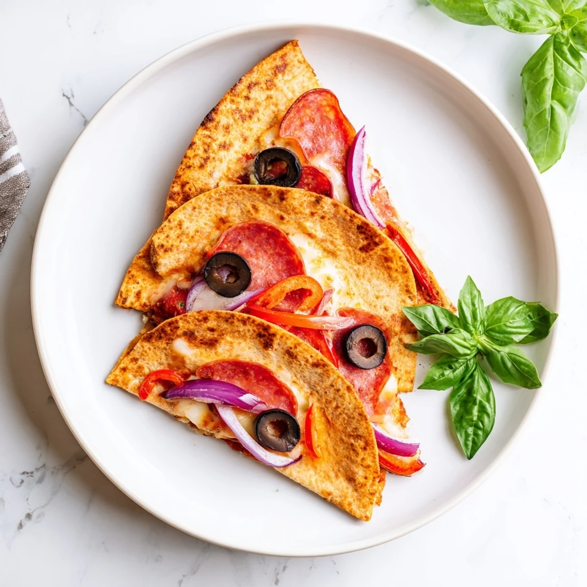 Delicious, easy Tortilla Pizza Wrap with a golden crust, savory toppings, and melted cheese, served hot on a plate.