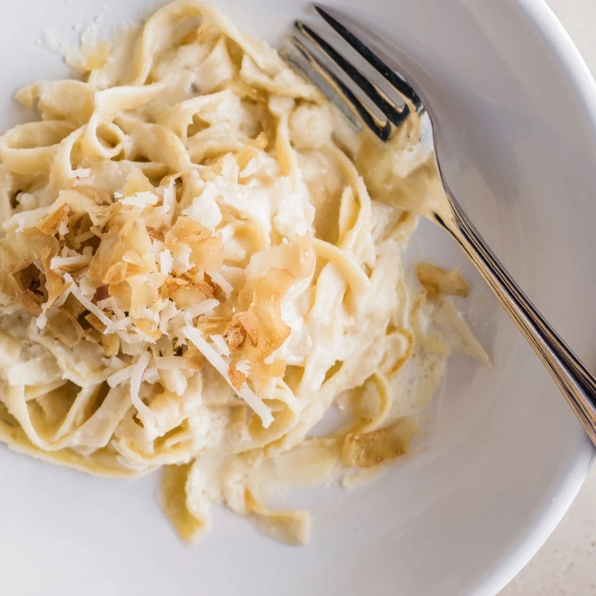 Steaming plate of homemade roasted garlic cream pasta, garnished with extra Parmesan and parsley, perfect for an easy vegetarian dinner.