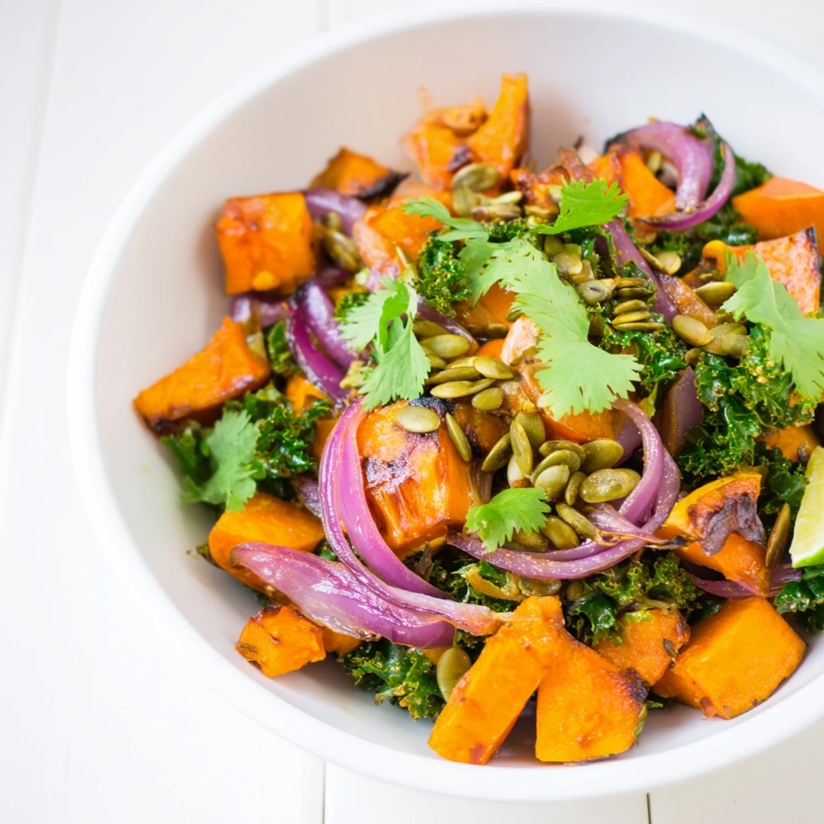 Roasted Sweet and Spicy Red Kuri Squash with warm spices and maple glaze in a bowl.