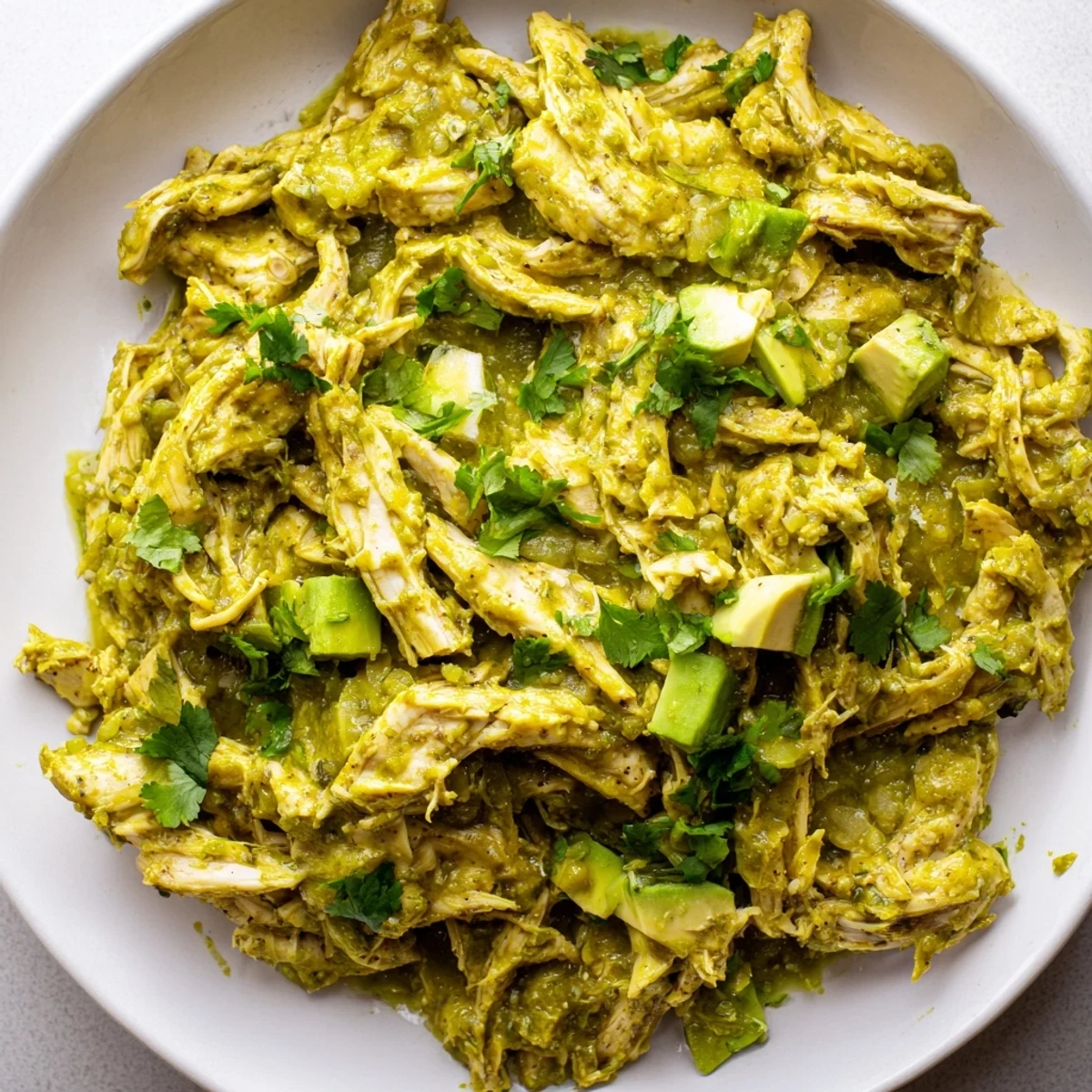 Sizzling boneless chicken thighs seared in a Dutch oven before being braised in a vibrant, charred green salsa verde, creating a rich and comforting Mexican classic main dish.