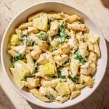 This Creamy Spinach Artichoke Protein Pasta Skillet showcases a close-up of tender pasta and creamy sauce, ready to serve.
