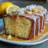Moist lemon-infused pound cake topped with a tangy Limoncello glaze, ideal for afternoon tea or weekend brunches.