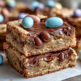 2. Chewy peanut butter cookie bars loaded with Easter egg candies, perfect for spring celebrations.