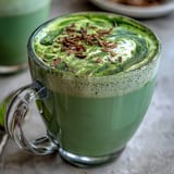 Close-up of a frothy Matcha Oat Milk Latte, smooth and refreshing, perfect morning drink.