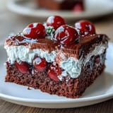 Moist chocolate cake infused with cherry cola Jello, perfect for dessert.