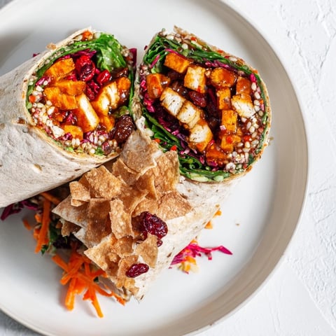 Crispy sweet chili tofu crunch wrap with a colorful holiday slaw, ready to eat.