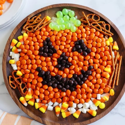 Vibrant Jack-o-Lantern Candy Board, a colorful Halloween dessert with orange candy base and a sweet smile.