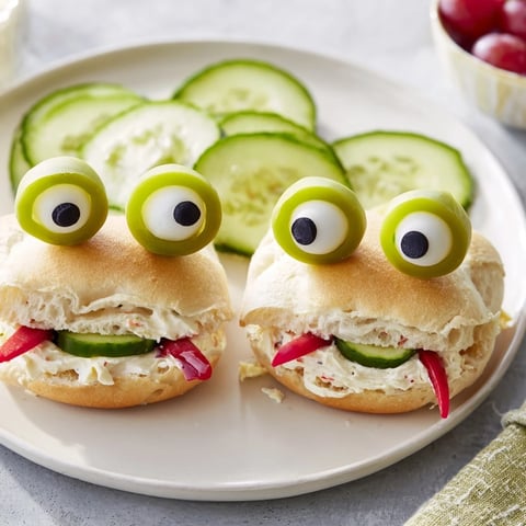 Vibrant Prince Charming Froggy Sandwich cutouts, ready to eat, featuring grape eyes and tomato cheeks.