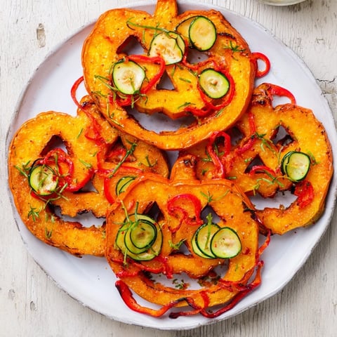 Roasted Pumpkin Lantern Halloween Plate, a vibrant mix of colorful veggies on a serving platter.