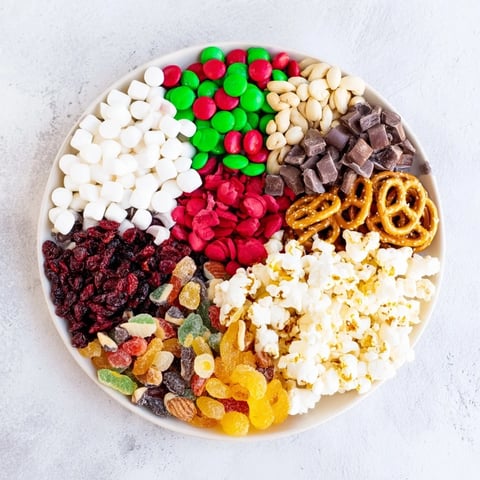 Vibrant Elf Snack Trail Mix board overflowing with colorful candies and crunchy pretzels, ready to eat!