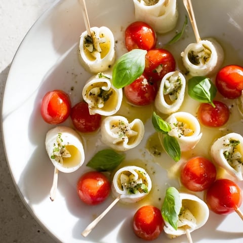 Savory star-shaped Caprese skewers: vibrant red tomatoes paired with creamy mozzarella stars and fragrant basil.