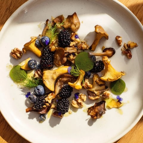 Image of the Northwest Forest Forager salad, featuring plump berries with earthy wild mushrooms.