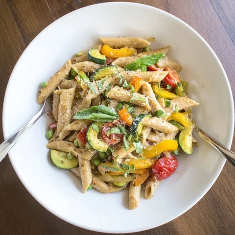 Creamy One-Pot Creamy Pasta Primavera with fresh zucchini, bell peppers, and cherry tomatoes in a rich Parmesan sauce.