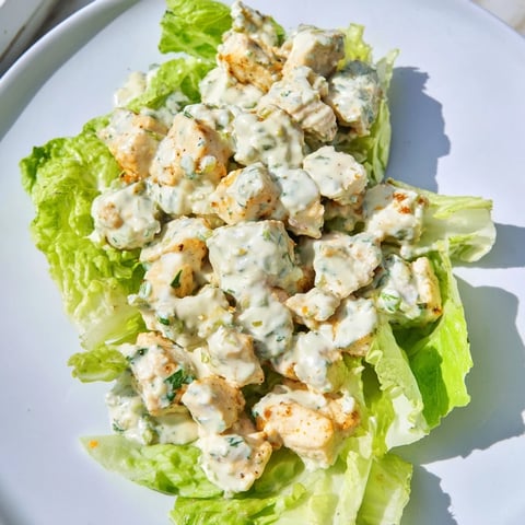 A vibrant Jalapeño Ranch Chicken Salad with tender chopped chicken, creamy dressing, and crisp romaine lettuce in a white bowl.