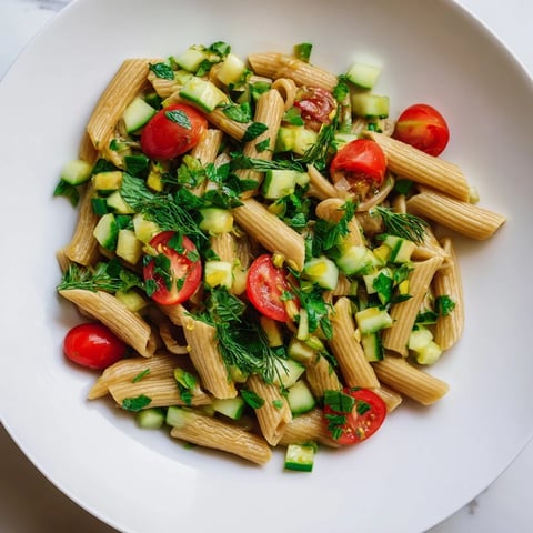 Bright, chilled Lemon Herb Chickpea Pasta Salad with diced cucumbers, cherry tomatoes, and fresh herbs tossed in zesty lemon dressing.