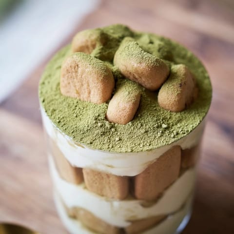 This chilled Matcha Mascarpone Tiramisu Snow Cup features fluffy mascarpone cream and delicate matcha dusting.