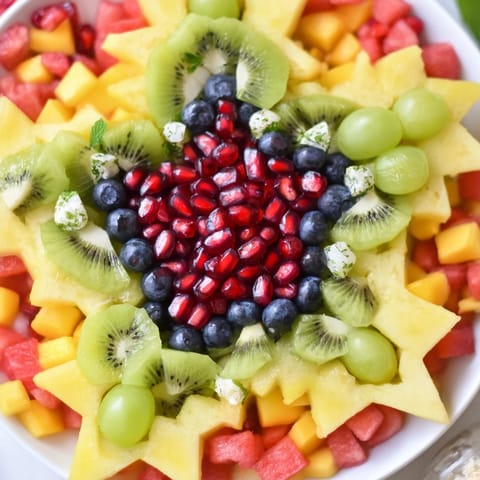 Vibrant Pomegranate and Mint Star Fruit Platter with sliced starfruit, a refreshing vegan snack or brunch appetizer idea.