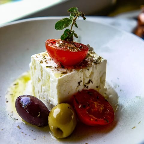 Vibrant skewers of tomatoes, olives, and feta cheese, perfect Holiday Cheers Olive and Feta Skewers to serve guests.