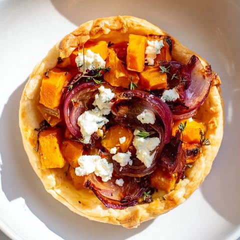Golden-brown Feuilles d'Érable Tartes Salées d'Automne, showcasing flaky pastry and roasted vegetable filling.