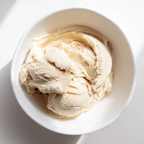 Homemade 2-Ingredient Banana Ice Cream offers a cold, sweet delight; bananas blended until luxuriously smooth and ready to scoop.