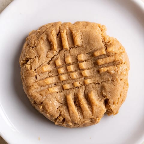 Warm and chewy Flourless Peanut Butter Cookies with a crisscross fork pattern, ready to enjoy.