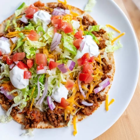 Perfectly browned ground beef smashed on crispy tortillas, ready to be devoured as Crispy Smash Tacos.