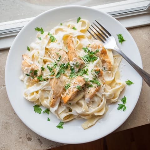 Golden chicken and glossy Alfredo sauce coat pasta in this comforting Skillet Chicken Alfredo, perfect for a family weeknight dinner.
