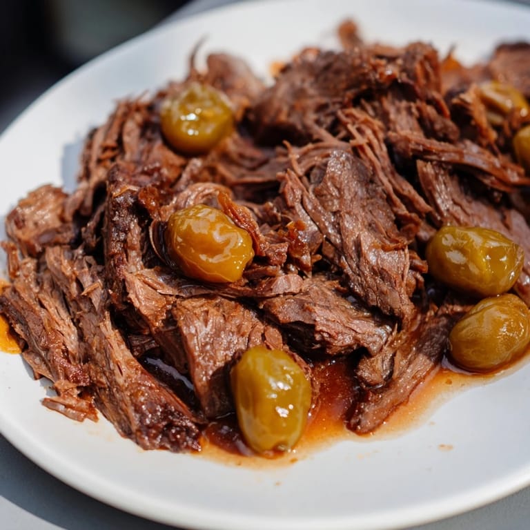 Close-up of fork-tender Slow Cooker Mississippi Pot Roast, rich with flavorful juices and butter.