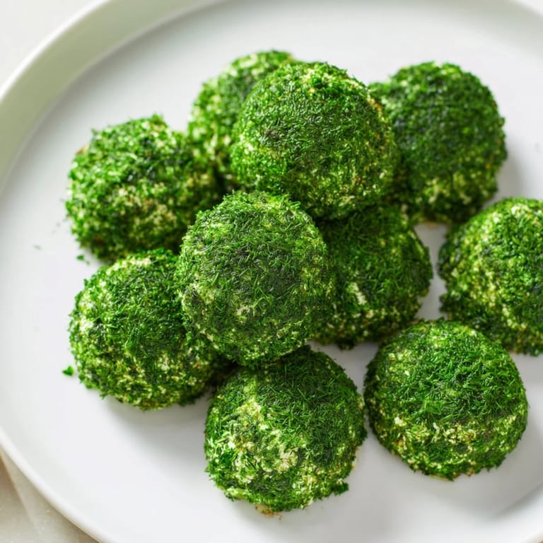 These delightful The Mossy Stone appetizers feature fresh herb-covered cheese, ready for your next gathering.