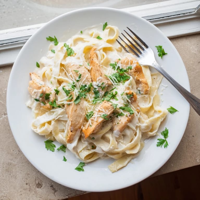 Golden chicken and glossy Alfredo sauce coat pasta in this comforting Skillet Chicken Alfredo, perfect for a family weeknight dinner.