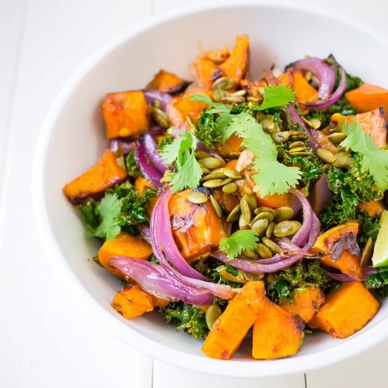 Roasted Sweet and Spicy Red Kuri Squash with warm spices and maple glaze in a bowl.