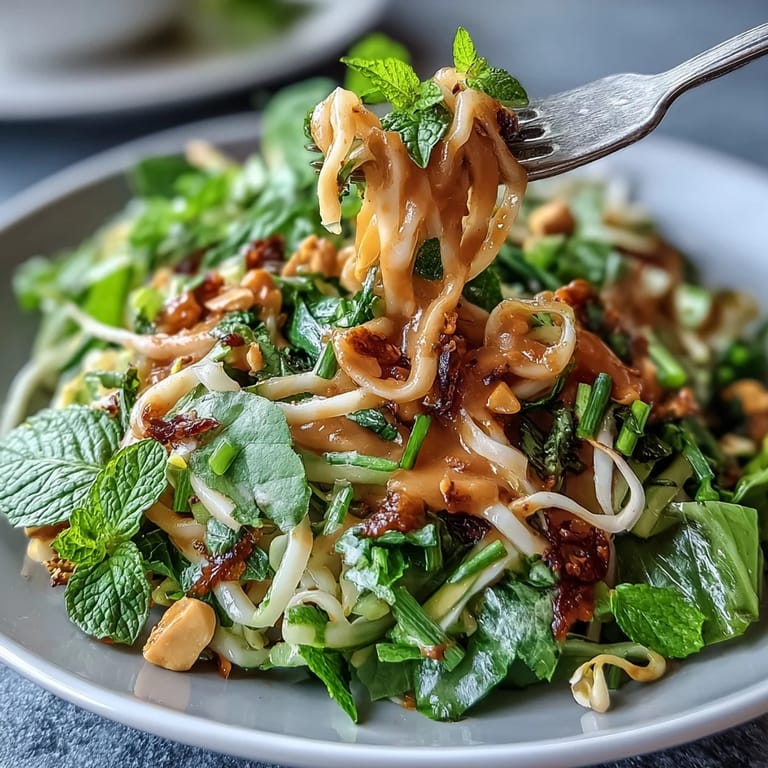Vibrant Vegan Spring Roll Salad with Peanut Dressing, featuring crisp cabbage, carrots, cucumber, and zesty lime-infused peanut sauce.  