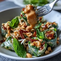 Fresh and colorful Vegan Spring Roll Salad with Peanut Dressing, loaded with crunchy veggies, herbs, and creamy avocado slices.  