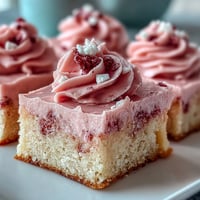 Soft sugar cookie bars with creamy strawberry frosting and sprinkles, perfect for Valentine's Day dessert platters.