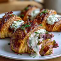 Ham & Swiss Croissant Bake with golden, flaky croissants, savory ham, and melted Swiss cheese in a creamy custard, baked to perfection for a comforting dinner.