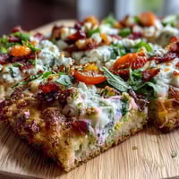St. Patricks Day Rainbow Veggie Flatbread Pizza with colorful vegetables arranged in a vibrant rainbow pattern on a crispy flatbread base.