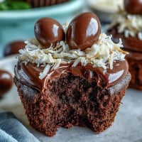 Delightful Easter nest cupcakes topped with rich chocolate buttercream and candy eggs, perfect for spring celebrations.  