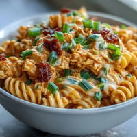 Creamy buffalo chicken pasta, a no-bake dish with spicy, tangy flavors and cooling ranch.