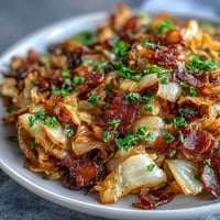Tender fried cabbage with bacon and onions, a savory Southern side.